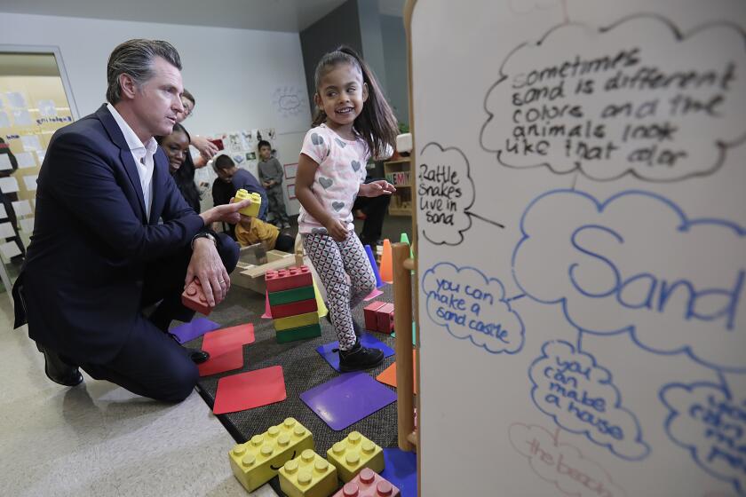 LOS ANGELES, CA, THURSDAY, AUGUST 8, 2019 - California Governor Gavin Newsom stacks blocks with Nahomy Corona, 4, while visiting the Hope Street Family Center to promote the StateÕs investment of $2 billion in early childhood development. (Robert Gauthier/Los Angeles Times)