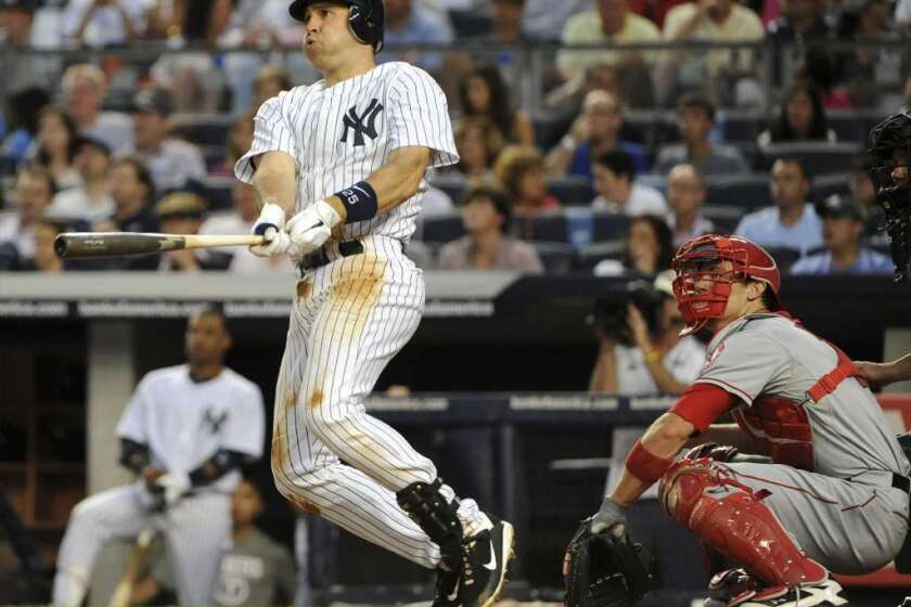 Mark Teixeira of the New York Yankees watches his home run in the bottom of the third inning against the Los Angeles Angels of Anaheim at Yankee Stadium on July 13, 2012.