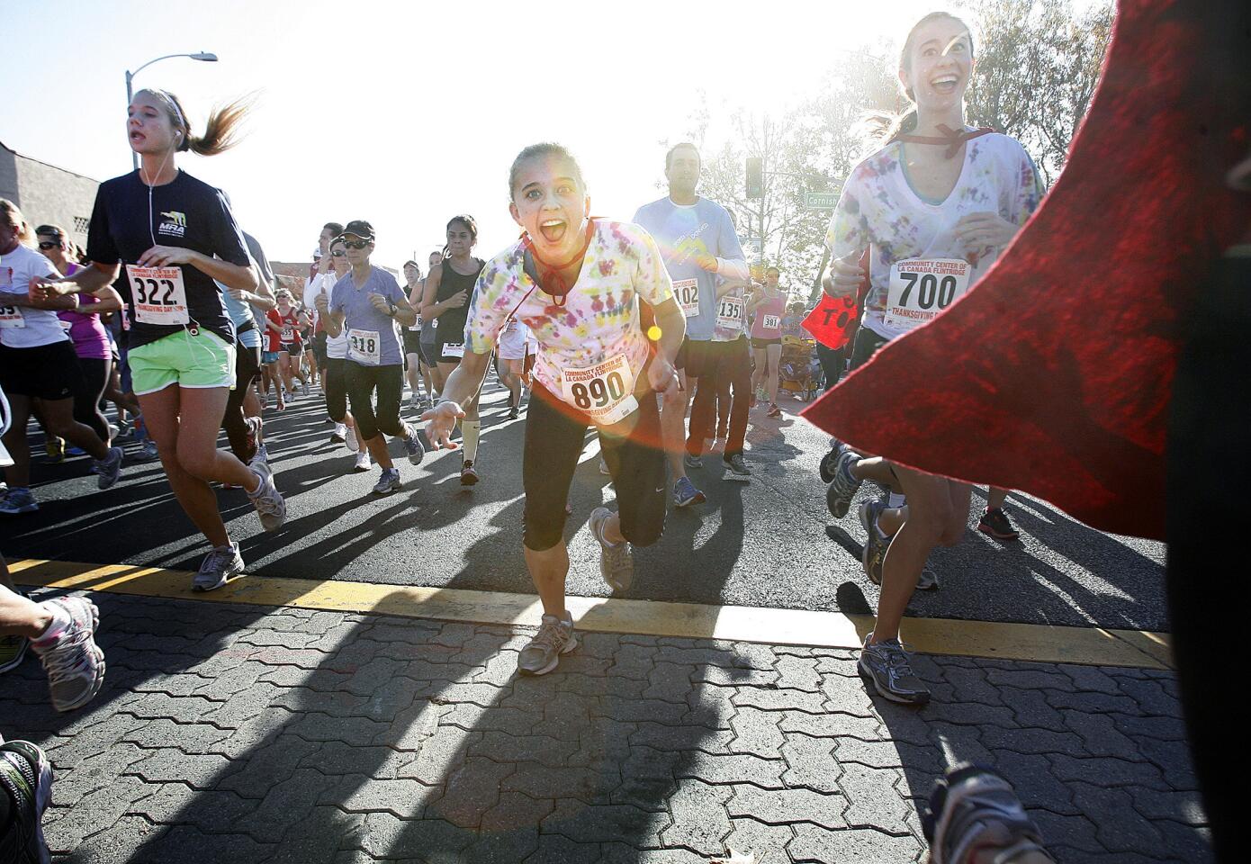 A solid wall of runners that span Foothill Blvd. start a fast-paced 5k trot at the Thanksgiving Fun Run and Food Drive, sponsored by the Community Center of La Canada Flintridge on Thanksgiving on Thursday, November 22, 2012.