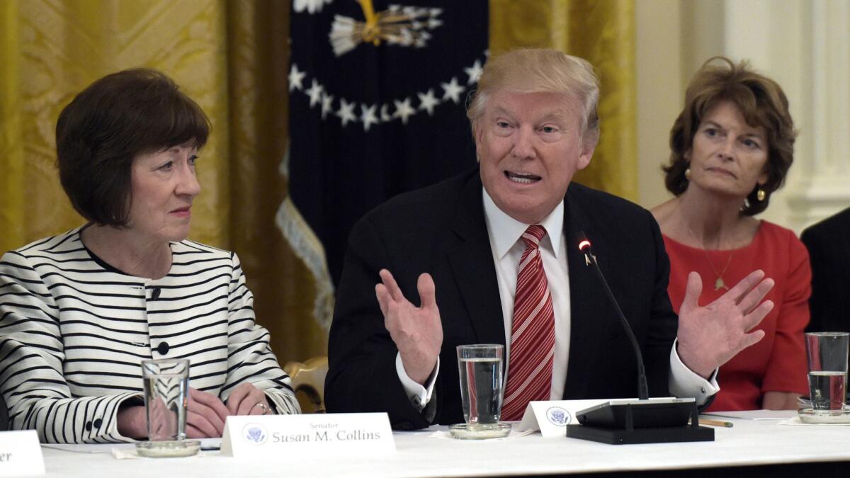 President Donald Trump, flanked by Republican Sens. Susan Collins of Maine (left) and Lisa Murkowski of Alaska at a White House meeting last year. The two moderates, both supporters of abortion rights, may now be key to the confirmation of Trump's next Supreme Court pick.