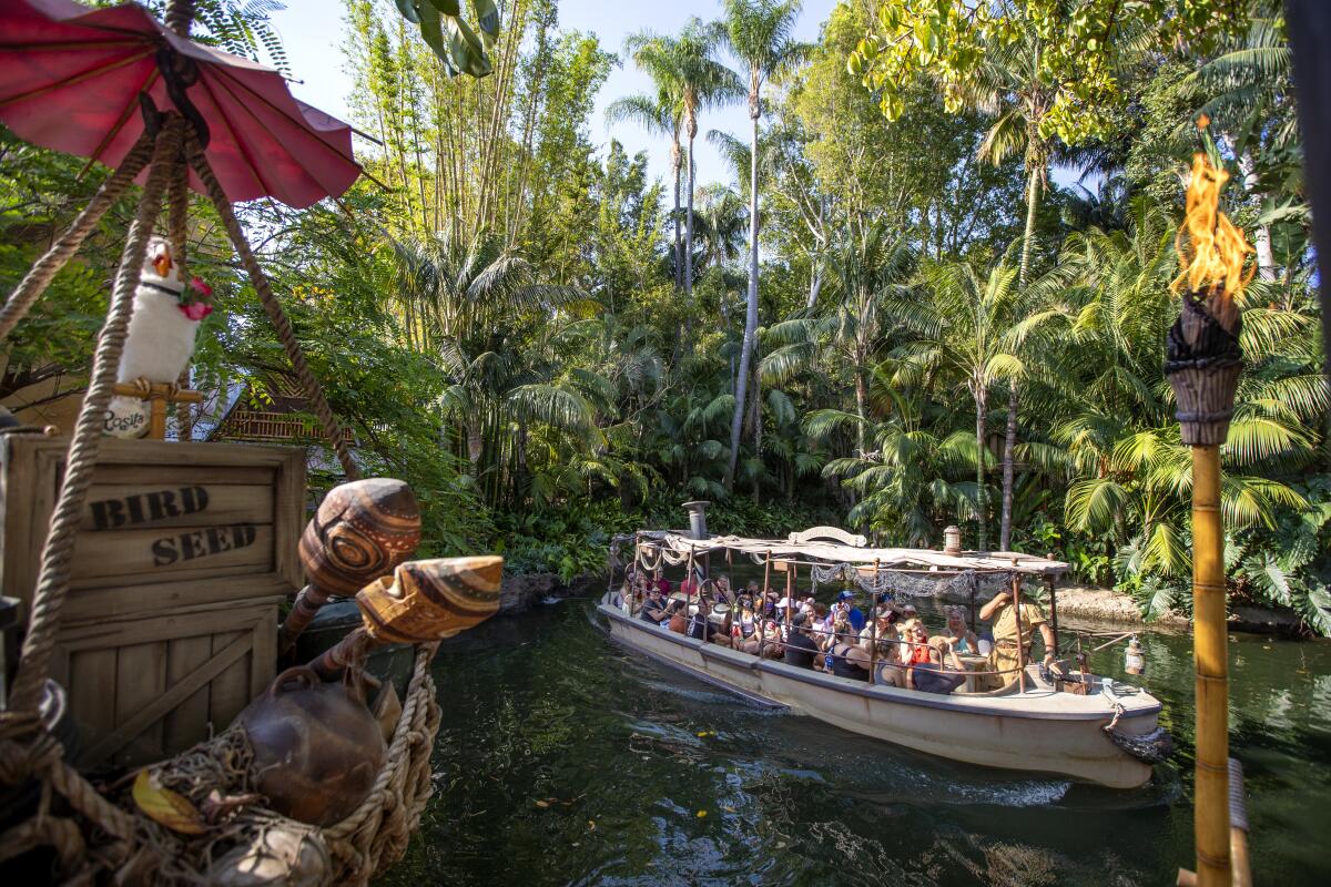 Passengers ride the Jungle Cruise ride at Adventureland in Disneyland.