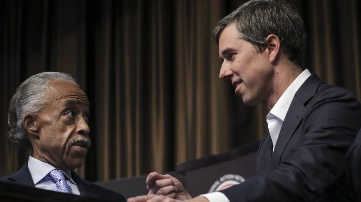 The Rev. Al Sharpton, left, speaks to former Rep. Beto O'Rourke at the National Action Network's annual convention in New York City. The meeting features speeches by many of the Democrats seeking the party's presidential nomination.