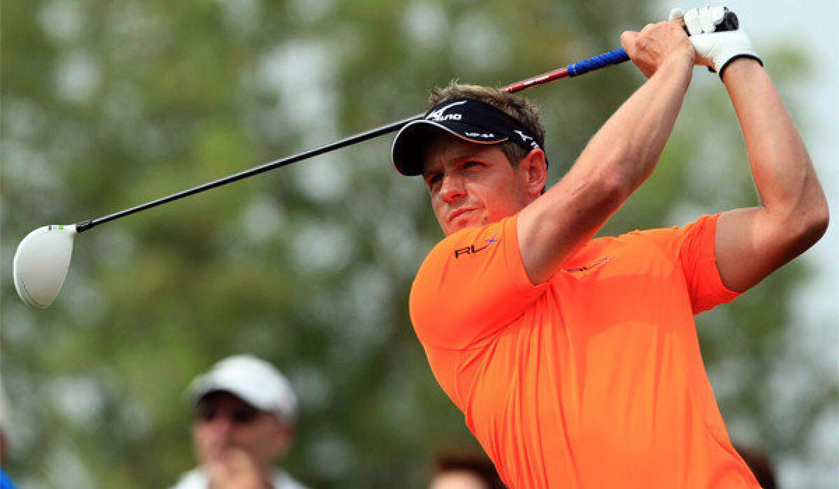 Luke Donald, above, is tied with Rory McIlroy after the third round of the Dubai World Championship in the United Arab Emirates.