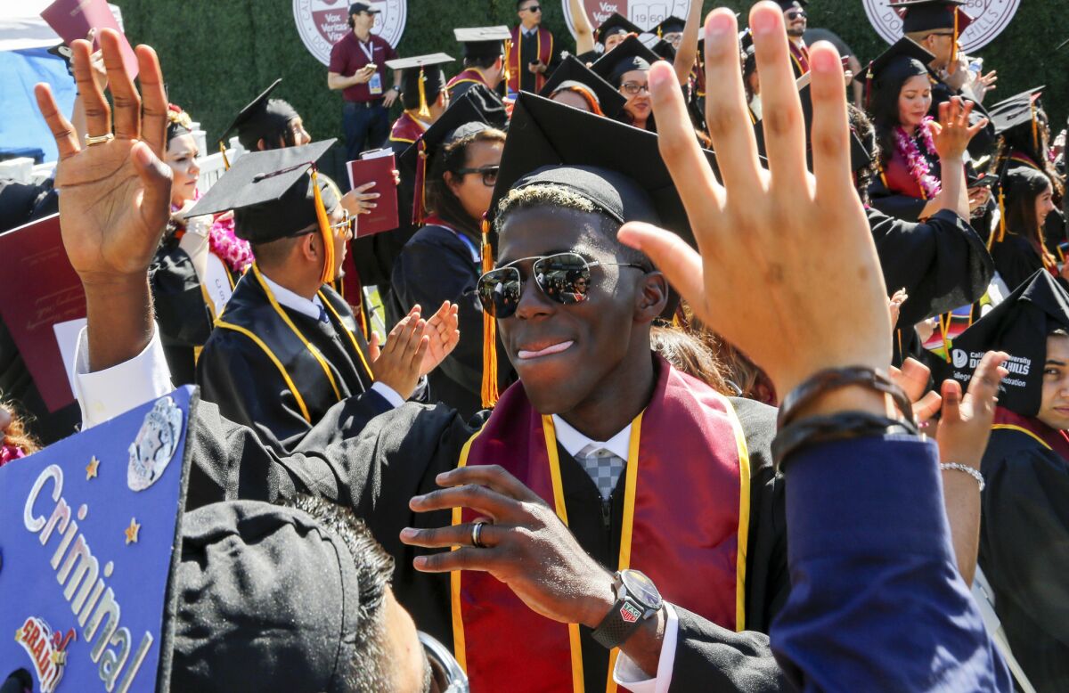 Gyasi Zardes celebrates with fellow Cal State Dominguez Hills graduates during their graduation ceremony.