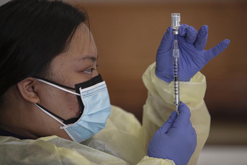 Lakewood, CA - March 31: Misheal Villano, a LVN, prepares Johnson & Johnson COVID-19 vaccine at coronavirus vaccination clinic established by L.A. County Department of Public Health at Whispering Fountains Senior Living Community on Wednesday, March 31, 2021 in Lakewood, CA.(Irfan Khan / Los Angeles Times)