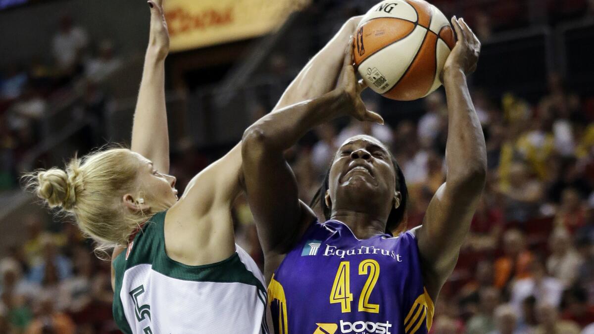Seattle's Abby Bishop tries to block a shot by the Sparks' Jantel Lavender during a game on June 6.