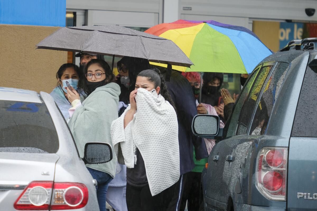 People look in shock in the aftermath of a shooting at a Burlington store in North Hollywood.