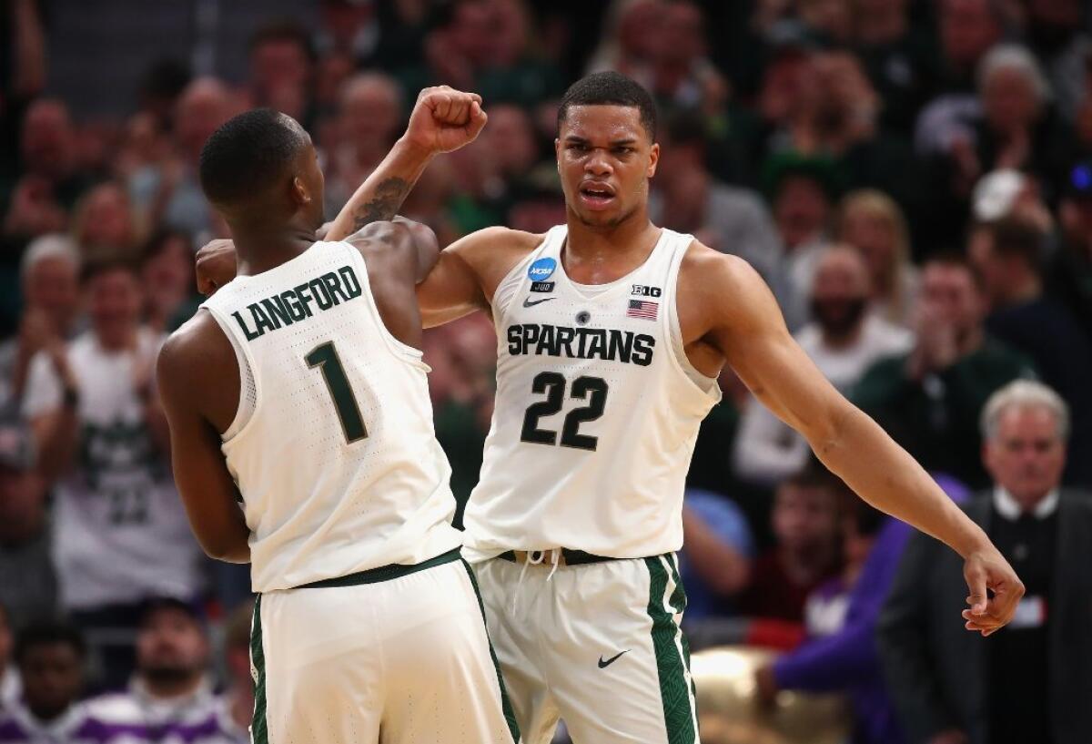Michigan State's Miles Bridges celebrates with Joshua Langford (1) during an NCAA tournament game against Bucknell.