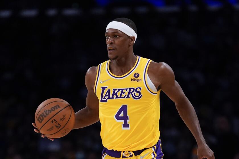 Los Angeles Lakers guard Rajon Rondo (4) controls the ball during an NBA basketball game against the Charlotte Hornets in Los Angeles, Monday, Nov. 8, 2021. (AP Photo/Ashley Landis)