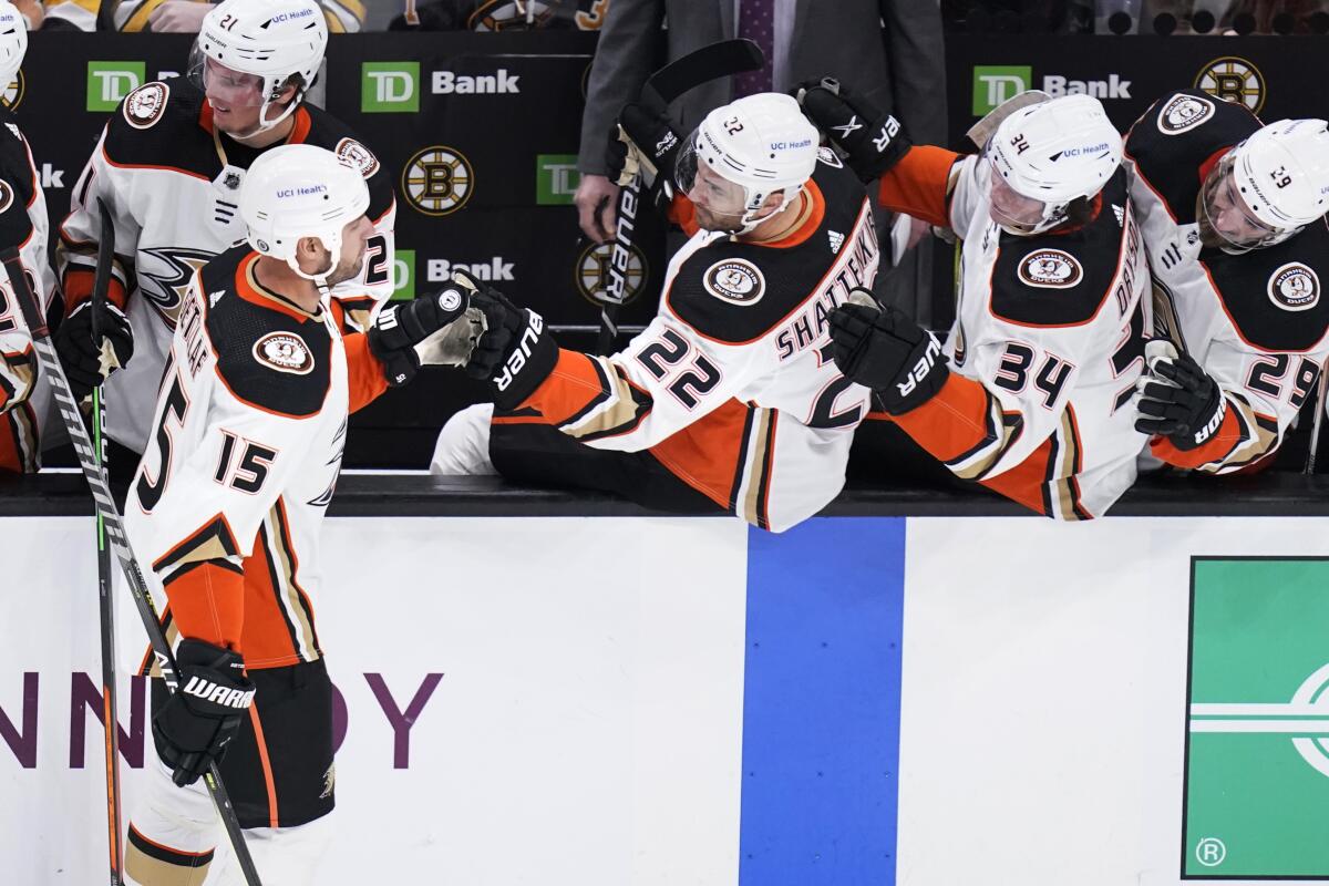 Ducks captain Ryan Getzlaf, left, celebrates with his teammates after scoring against the Boston Bruins.