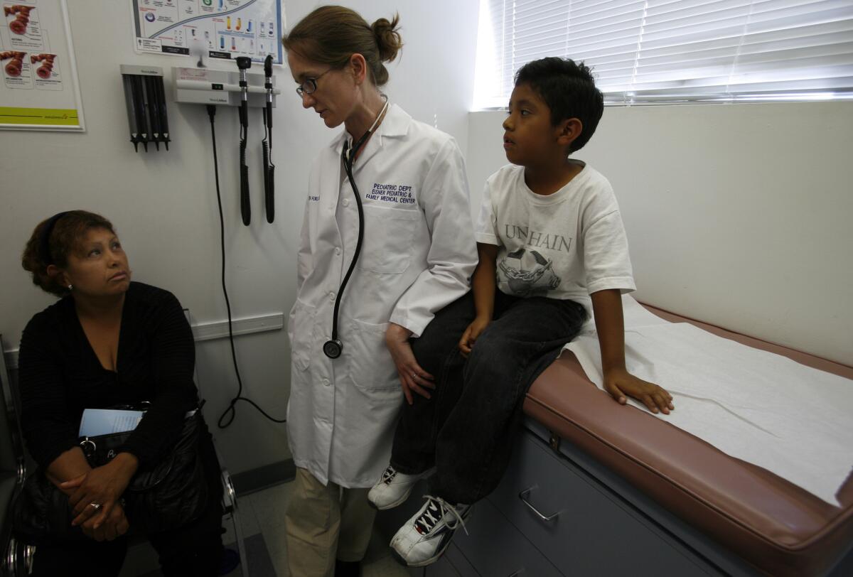 Arcelia Escamilla, 39, speaks with Dr. Elizabeth Ford about her son Kevin Tlatoa, 6, of South Los Angeles in 2009. State officials are phasing out the Healthy Families program that Kevin was enrolled in and shifting all the children into Medi-Cal.