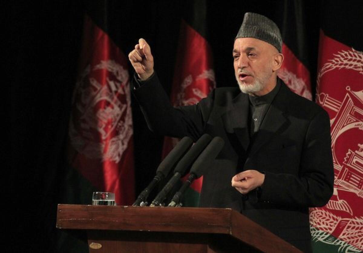 Afghan President Hamid Karzai speaks during an event commemorating International Women's Day in Kabul. During the speech, Karzai accused the United States of conspiring with the Taliban to foment violence in Afghanistan.