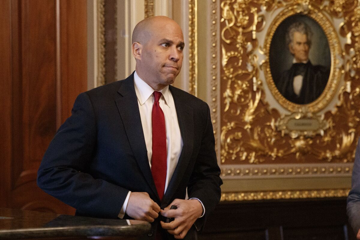Sen. Cory Booker, D-N.J., walks to the Senate chamber, Tuesday, Jan. 28, 2020, on Capitol Hill in Washington, for the impeachment trial of President Donald Trump on charges of abuse of power and obstruction of Congress. (AP Photo/ Jacquelyn Martin)