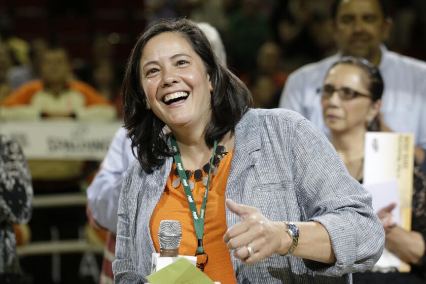 Outgoing Seattle Storm CEO and president Karen Bryant smiles as she is honored on her last day before a WNBA basketball game