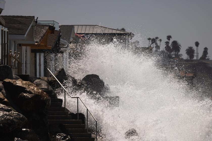 San Clemente, California - July 30, 2026: Waves crash onto houses in Dana Point, on Thursday, July 30, 2026, in San Clemente, California. Waves reached 4 ft during this morning's high tide. Southern California coastlines are experiencing strong rip currents and high surf advisory conditions coinciding with an active south swell. (Arwen Clemans/Los Angeles Times)