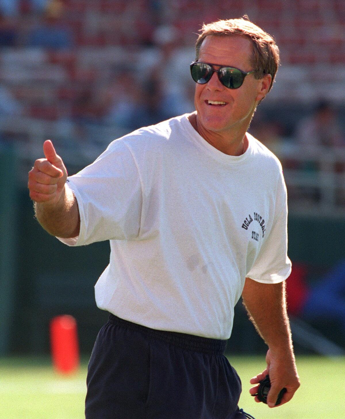 UCLA football coach Terry Donohue gives a thumbs up during a practice at the Rose Bowl in 1995.