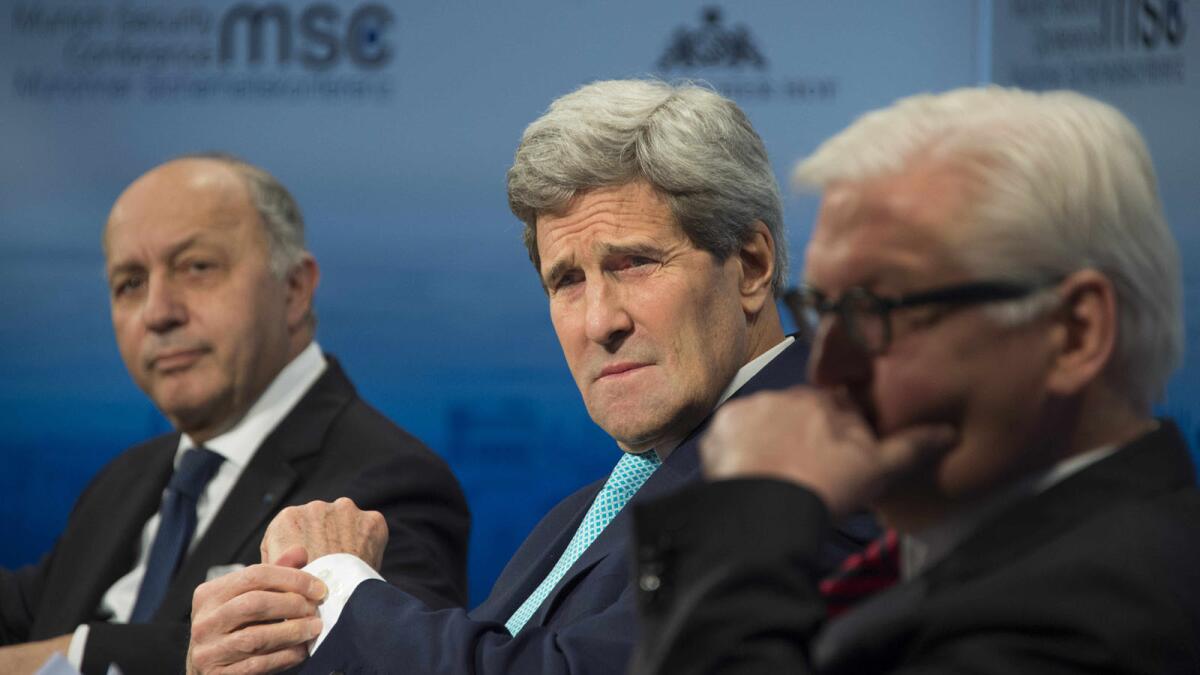 U.S. Secretary of State John F. Kerry, center, talks with French Foreign Minister Laurent Fabius, left, and German Foreign Minister Frank-Walter Steinmeier at the 51st Munich Security Conference.