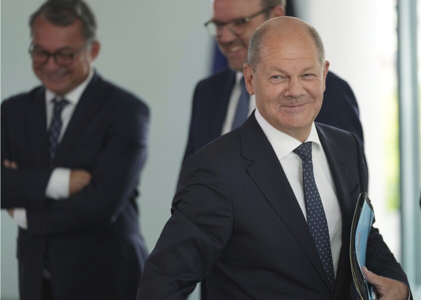 German Chancellor Olaf Scholz, front, arrives for the 'Concerted Action', a meeting of representatives of the German unions and the German employers with the German government at the Chancellery in Berlin, Germany, Monday, July 4, 2022. (AP Photo/Michael Sohn)
