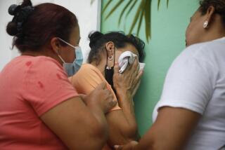 Family members wait in distress outside the entrance to the women's prison in Tamara, on the outskirts of Tegucigalpa, Honduras, Tuesday, June 20, 2023. A riot at the women's prison has left at least 41 inmates dead, most of them burned to death, a Honduran police official said. (AP Photo/Elmer Martinez)