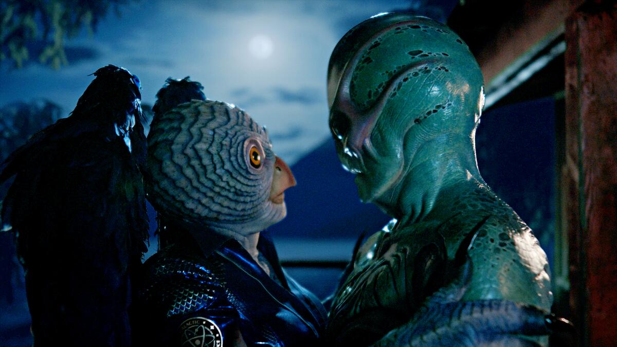 Two alien creatures look at each other lovingly in a scene from "Alien resident."