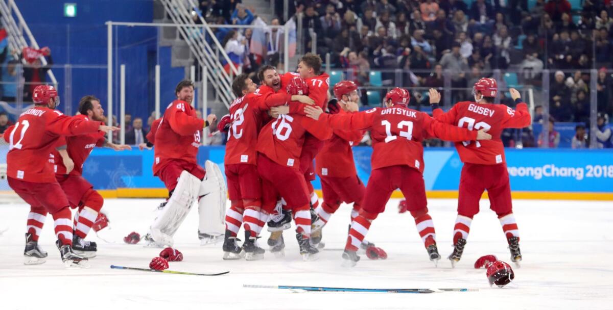 Kirill Kaprizov (77) celebrates with Olympic Athletes from Russia teammates after scoring the winning goal against Germany on Sunday.
