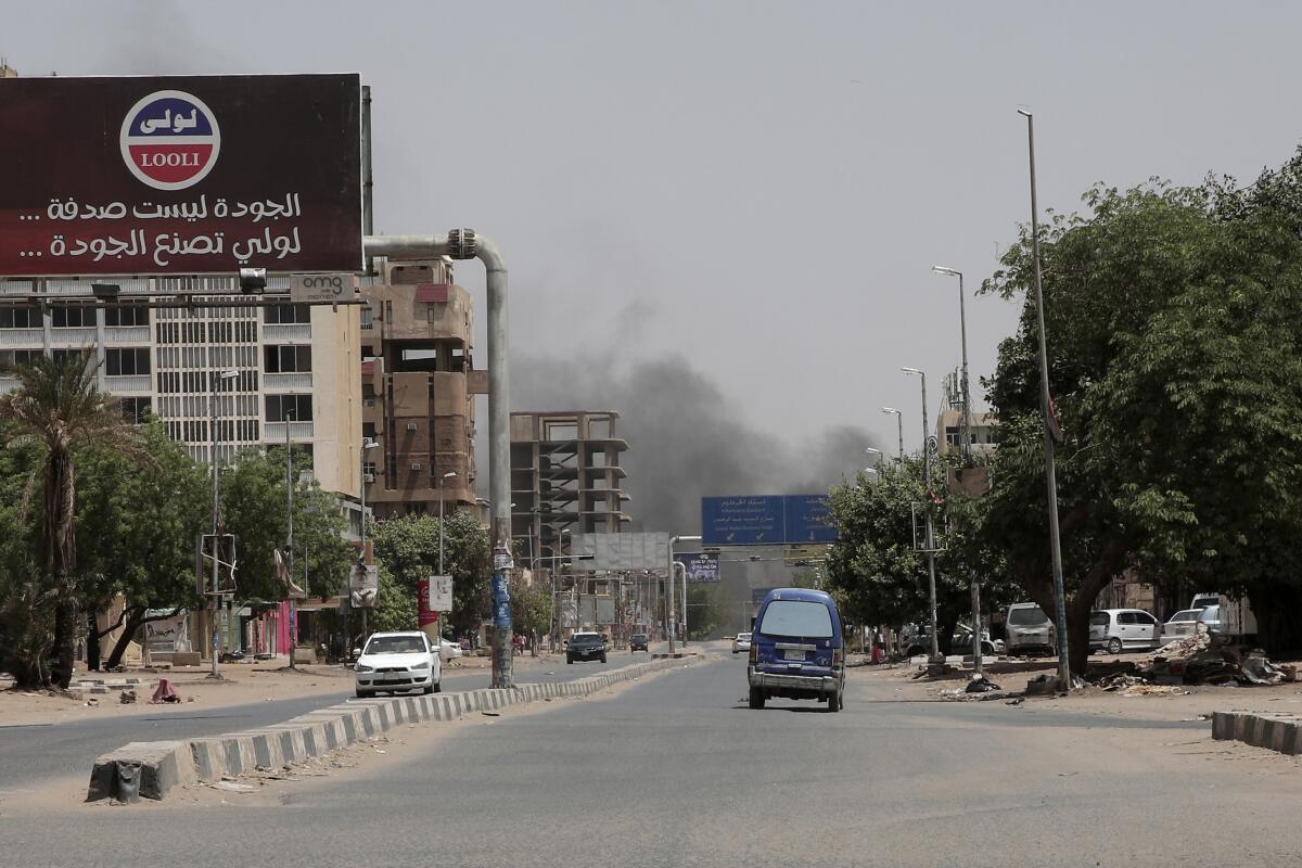 Smoke rises from a neighborhood in Khartoum, Sudan.