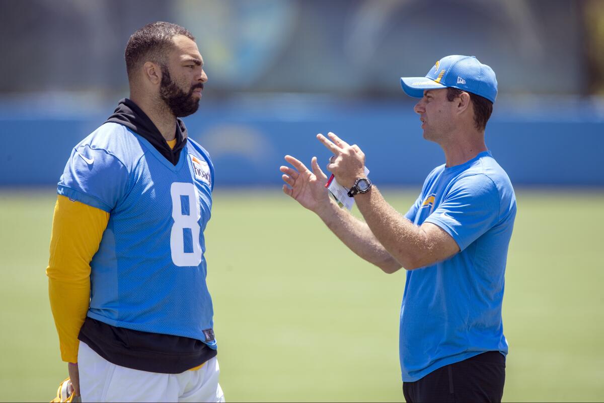 Chargers linebacker Kyle Van Noy, left, and head coach Brandon Staley talk after drills in Costa Mesa.