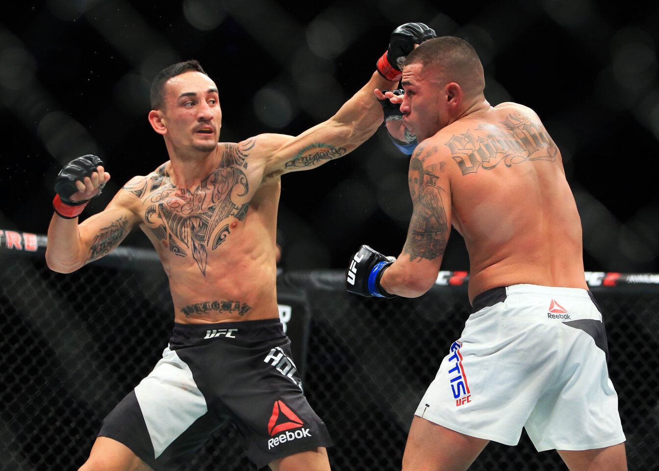TORONTO, ON - DECEMBER 10: Max Holloway (L) of the United States fights Anthony Pettis (R) of the United States for the Interim Featherweight Title during the UFC 206 event at Air Canada Centre on December 10, 2016 in Toronto, Canada. (Photo by Vaughn Ridley/Getty Images) ** OUTS - ELSENT, FPG, CM - OUTS * NM, PH, VA if sourced by CT, LA or MoD **
