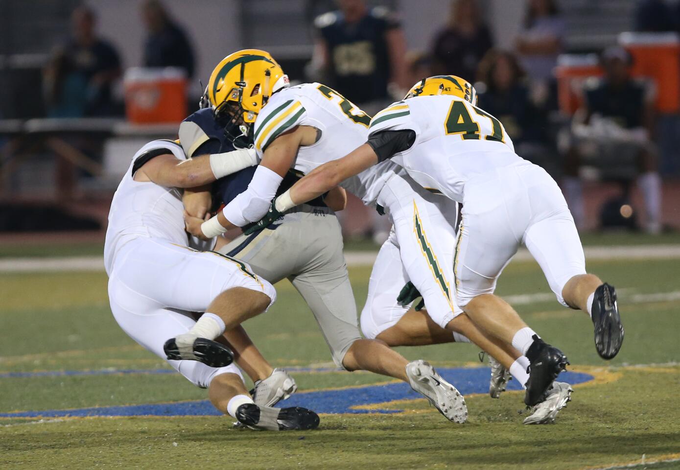 Edison High's Cameron Eden (1), Mike Walters (2), and Bryce Gilbert (47) take down San Juan Hills' quarterback Jake Carreon during non league football at San Juan Hills on Friday.