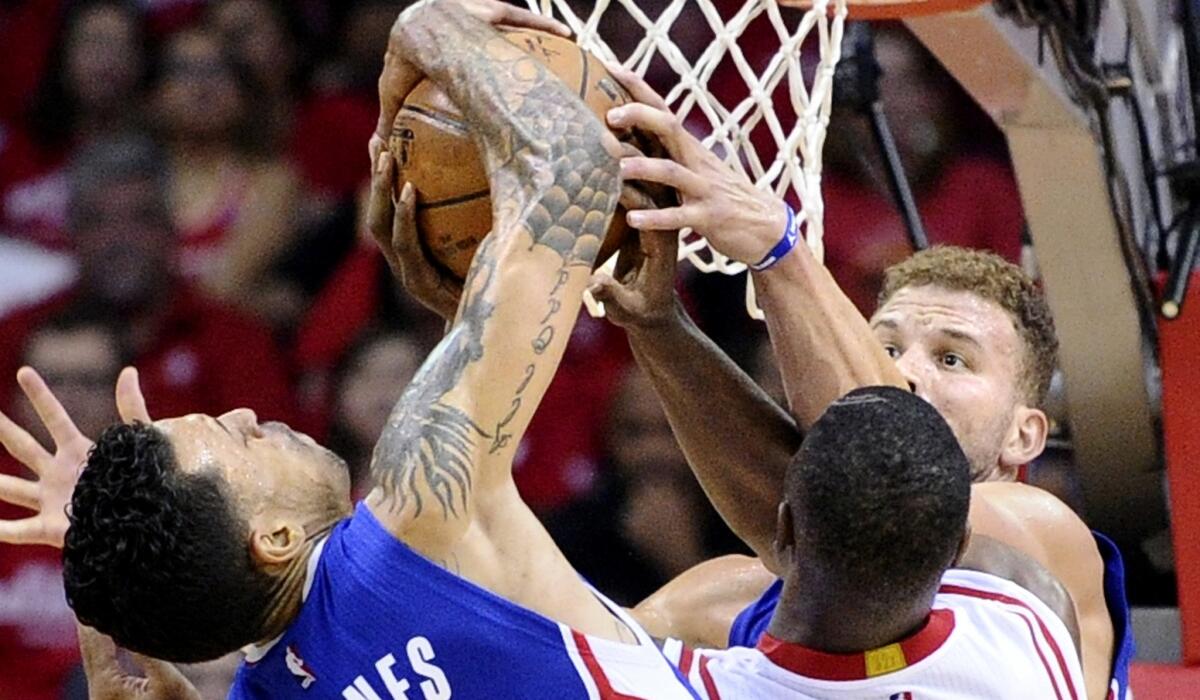 Clippers forward Matt Barnes, left, blocks a shot by Rockets forward Terrence Jones in the first half of Game 2 on Wednesday night in Houston.