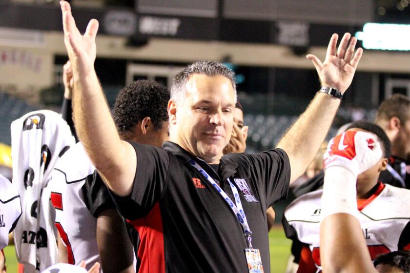 Coach Matt Logan celebrates with his Corona Centennial players during their Pac-5 Division championship victory.