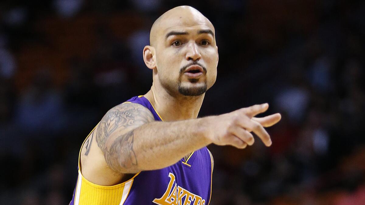 Lakers center Robert Sacre calls a play during a loss to the Miami Heat on March 4.