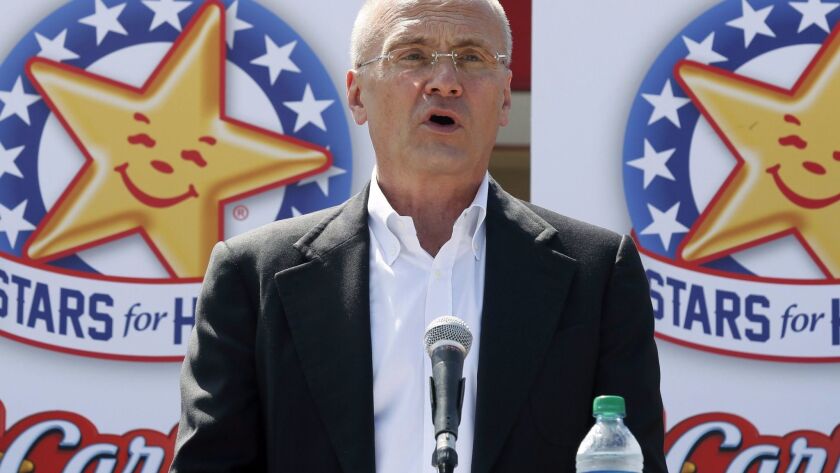 Former CKE Restaurants CEO Andy Puzder stands in front of the star icon that serves both Hardee's and Carl's Jr. restaurants.