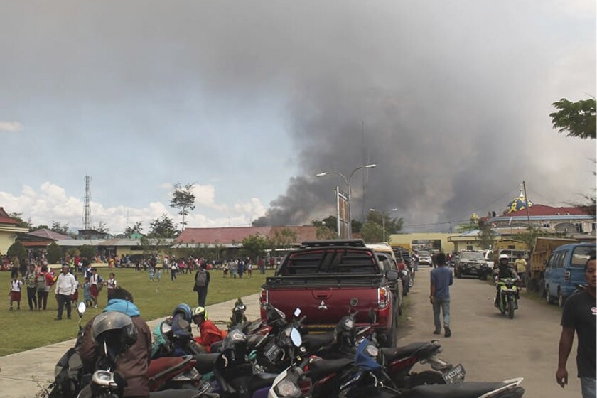 Smoke billows from a burning building during protests Sept. 23 in Wamena, Papua province, Indonesia.