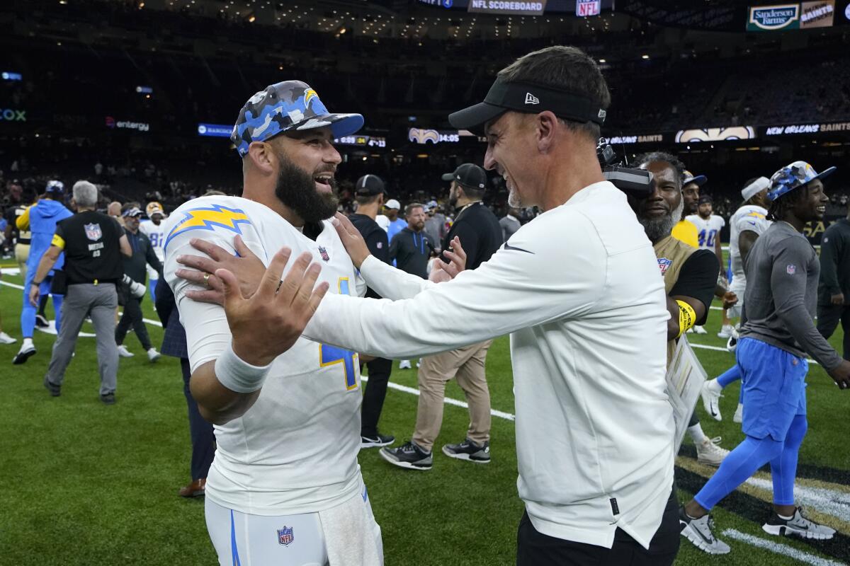 Los Angeles Chargers quarterback Chase Daniel greets New Orleans Saints head coach Dennis Allen, right, after a preseason NFL football game in New Orleans, Friday, Aug. 26, 2022. The Saints won 27-10. (AP Photo/Gerald Herbert)