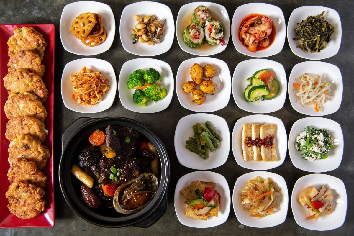 Food arranged on multiple platters including 16 small white dishes.