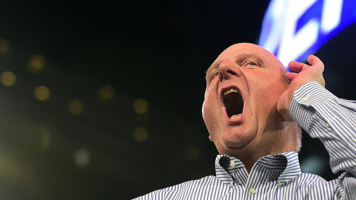 Clippers owner Steve Ballmer gestures in an effort to draw a response from the crowd attending a fan rally at Staples Center in August.