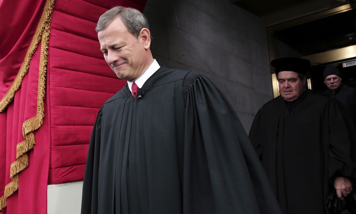 Efforts are underway to attempt to overturn the controversial Supreme Court "Citizen's United" decision. Above, Chief Justice John Roberts, followed by Justice Antonin Scalia in January of 2013.