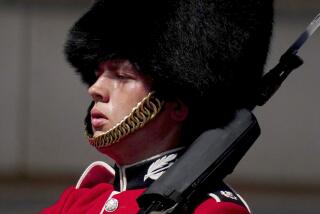 A member of F Company Scots Guards swelters in the heat during the Changing of the Guard ceremony on the forecourt of Buckingham Palace, central London, Tuesday July 19, 2022. Millions of people in Britain woke from the country’s warmest-ever night on Tuesday and braced for a day when temperatures could break records, as a heat wave scorching Europe walloped a country not built for such extremes (Victoria Jones/PA via AP)