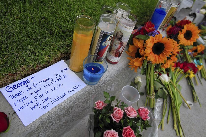 Flowers and a note to one of the victims have been placed outside the apartment where Elliot Rodger stabbed three housemates to death.