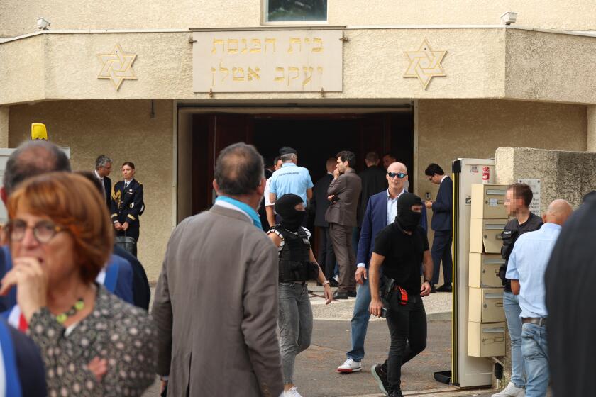 Anti-Terrorist Sub-Directorate (SDAT) judicial police officers (Centre-L and Centre-R) walk out of the synagogue which was set on fire and were an explosion of cars occured in La Grande-Motte, south of France, on August 24, 2024. At least two cars, one containing a gas bottle, were set alight on the morning of August 24, 2024, in front of the synagogue in La Grande-Motte, causing an explosion that injured a local policeman, the French gendarmerie and the town's mayor said. (Photo by Pascal GUYOT / AFP) (Photo by PASCAL GUYOT/AFP via Getty Images)