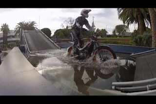 L. A. Auto Show: Trials bike on Land Rover obstacle course