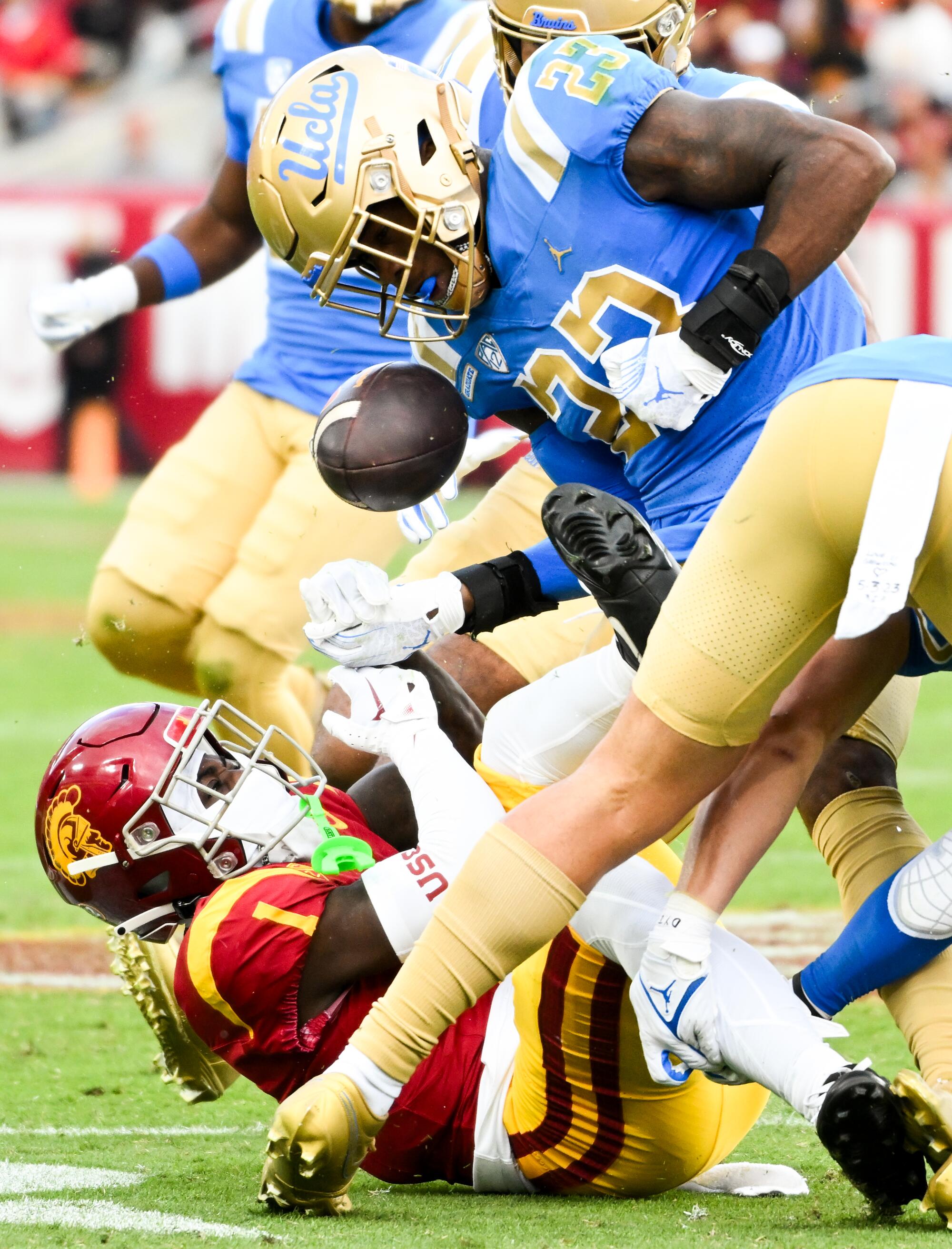 UCLA Bruins defensive back Kenny Churchwell III forces a fumble by USC Trojans wide receiver Zachariah Branch 