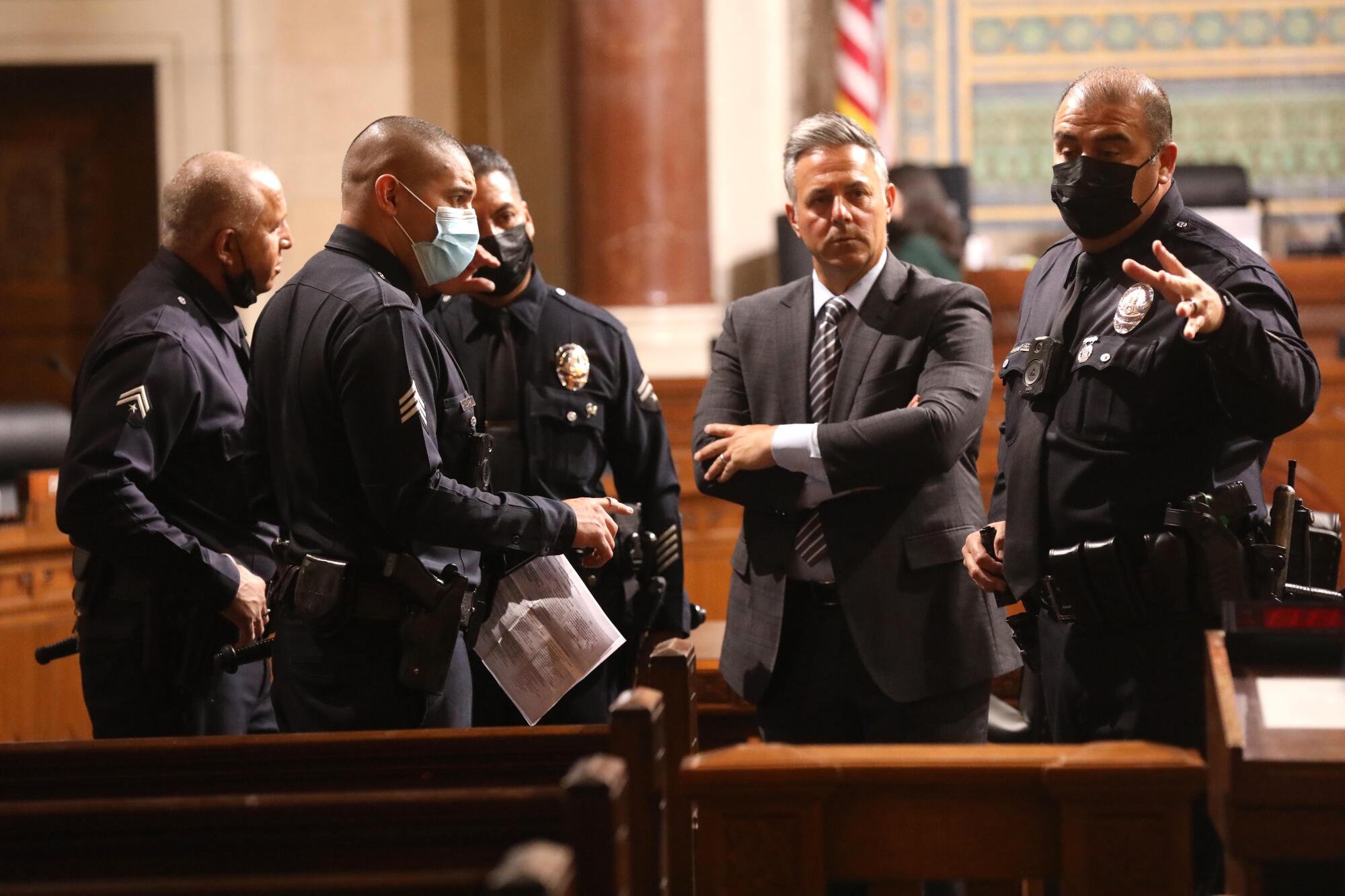 Los Angeles City Councilman Joe Buscaino confers with police