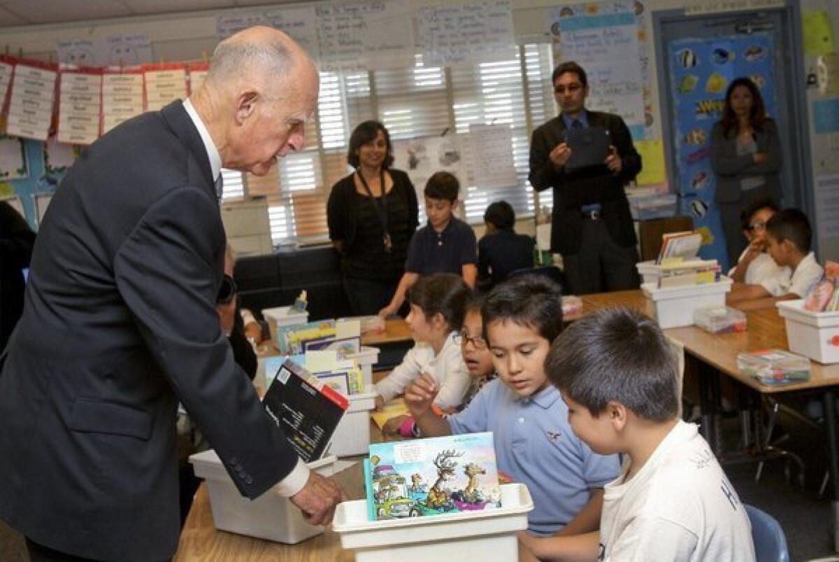 Gov. Jerry Brown talks with second-graders at Perkins Elementary School in San Diego last month.