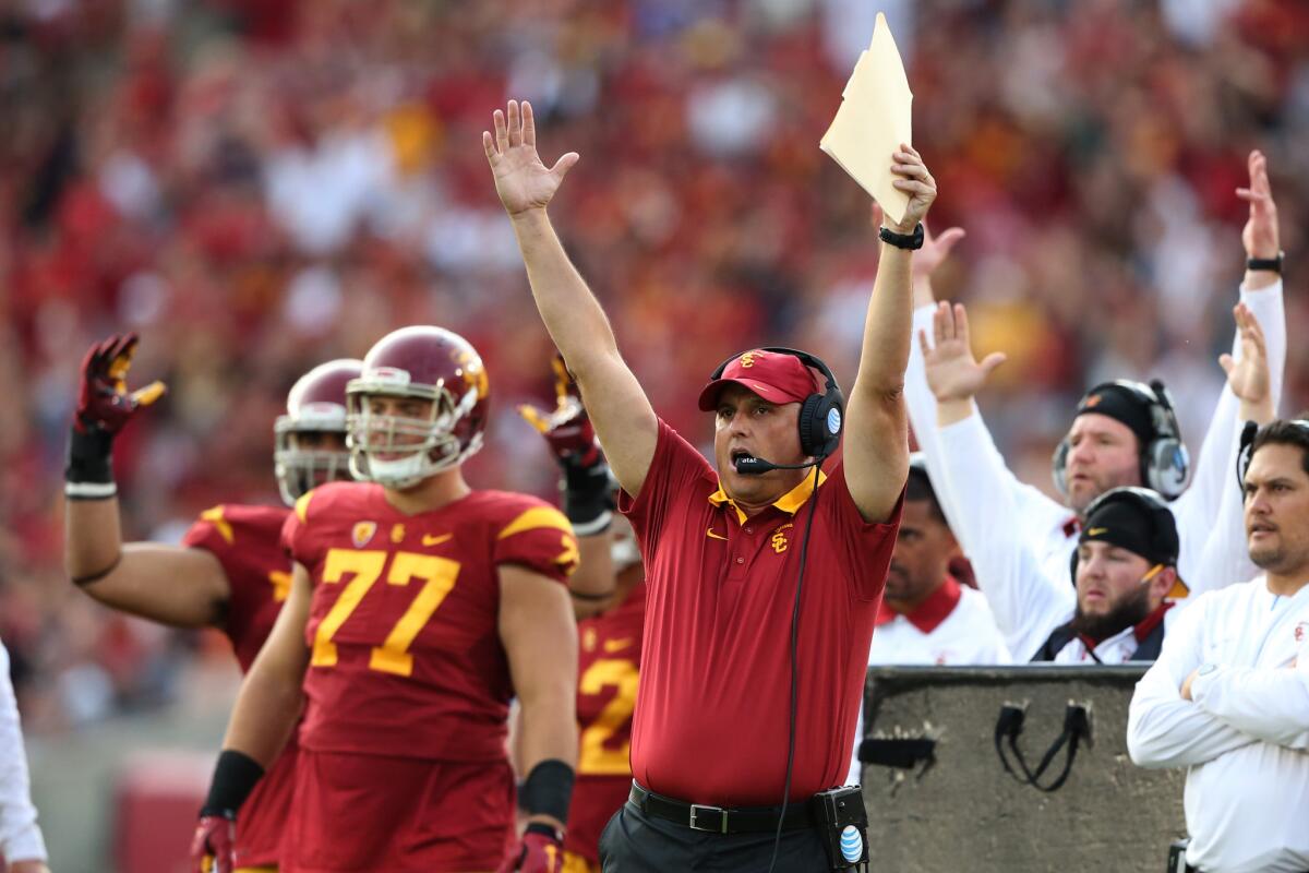 USC interim Coach Clay Helton signals touchdown after fullback Soma Vainuku scores during the second quarter of a game against Utah on Oct. 24.