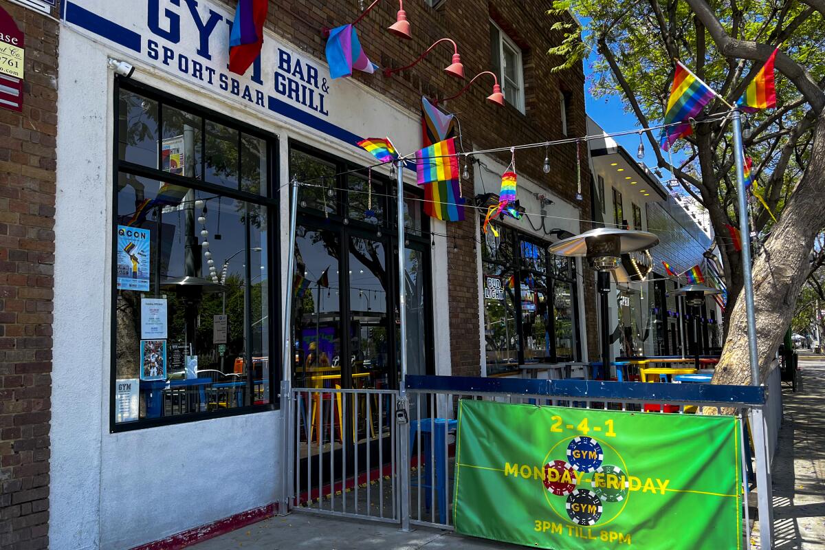 Gym Bar's storefront with pride decorations.