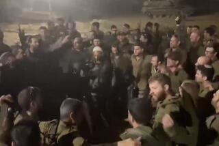 This image made from an undated video shared on X, formerly known as Twitter, shows Israeli Army troops with their arms slung around each other, chanting racist slogans as they dance in a circle, in Gaza. Several viral videos of Israeli soldiers behaving inappropriately in Gaza have emerged in recent days, creating a headache for the Israeli military as it faces an international outcry over its tactics and the rising civilian death toll in its war against Hamas. (X via AP)