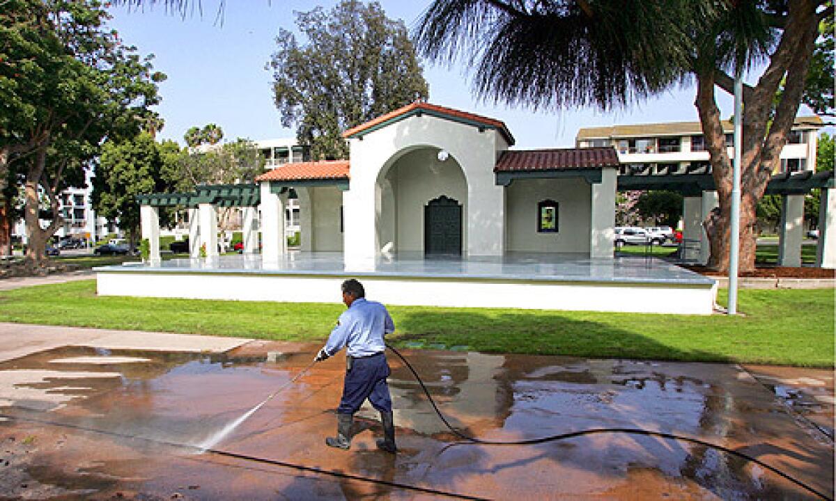 Long Beach city worker Luis Oviedo was washing down the pavement at Bixby Park in Long Beach on May 9, 2008. The Bixby Park band shell in Long Beach has been refurbished and re-opens today.