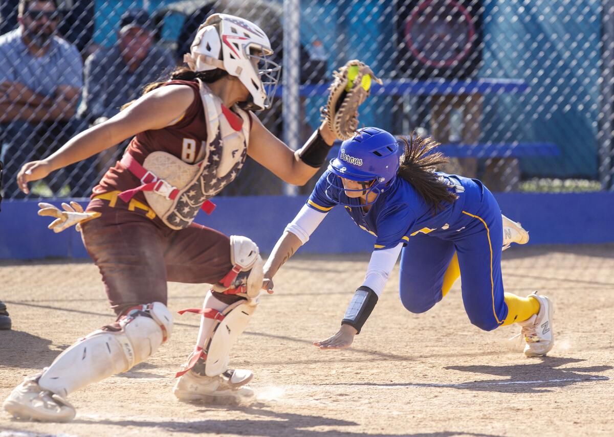 Fountain Valley's Marissa Sardinas beats the throw at home and scores on a throwing error in the fifth inning.